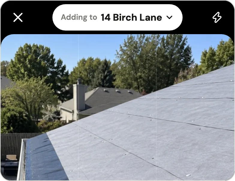 Handle's camera with "Adding to 14 Birch Lane" at the top, above a sample photo of a roof with new underlayment