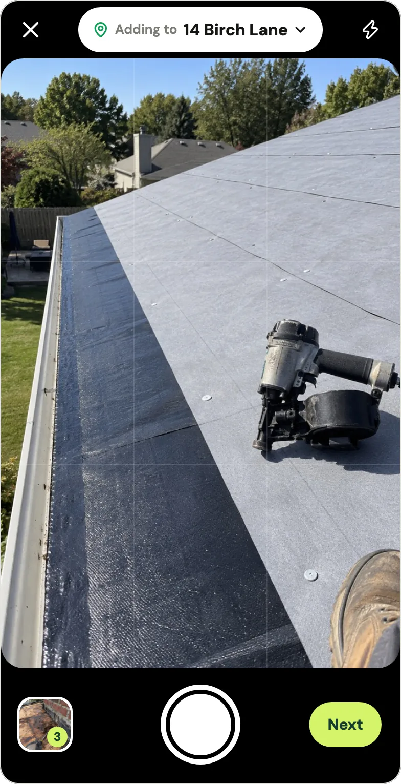 Handle's camera on a roof job: at the top, Adding to 14 Birch Lane with a green location pin and a chevron to change it; in the frame, the app's stand-in sample picture of new underlayment and ice and water shield along a gutter with a roofing nailer; at the bottom, a stack of three shots taken, the shutter button and Next. From Handle's fictional example crew.
